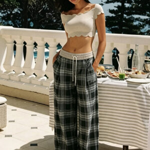 Women's high-waisted wide-leg trousers featuring a vintage black-and-gray plaid print, embodying a relaxed, casual street-style aesthetic with straight-cut, floor-length design.